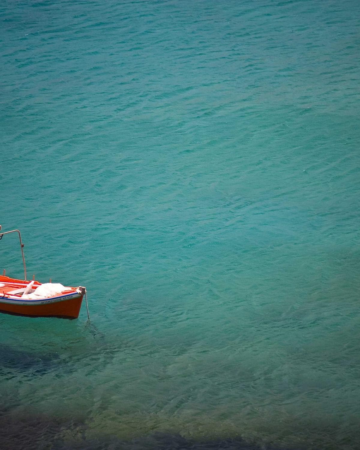 Deep blue water with a single descending line